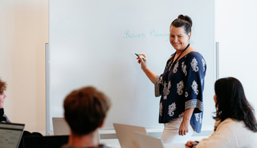 Business tutor teaching a class
