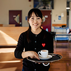 Barista student serving coffee