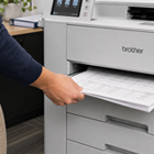 Person pulling out paper of a printer