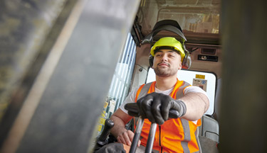 Forestry student operating machinery
