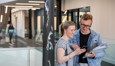 Students looking at a phone