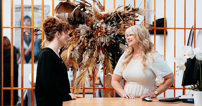 Hair and Beauty tutor talking with client