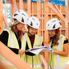 Health and Safety students with tutor looking over plans