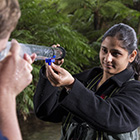 Environmental students looking through turbidity tube