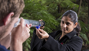 Environmental students looking through turbidity tube