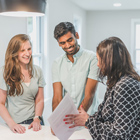 Real Estate agent talking to potential home buyers
