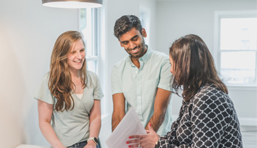 Real Estate agent talking to potential home buyers