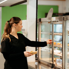 Toi Ohomai student grabbing food out of the food warmer