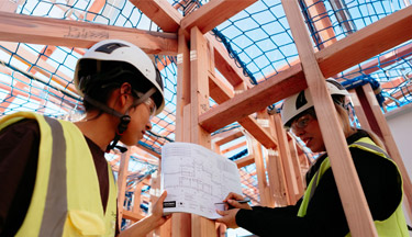 Student looking over building plans