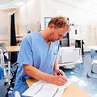 Enrolled nursing student writing notes