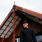 Toi Ohomai student standing outside Tangatarua Marae