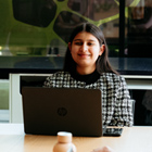 Postgraduate student studying with other students