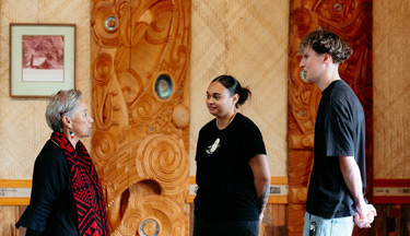 Toi Ohomai students inside Tangatarua Marae talking to Kaitiaki Māori (Wahine)