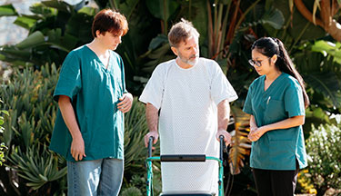 Healthcare Assistants helping a patient