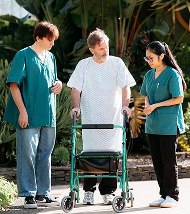 Healthcare Assistants helping a patient