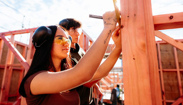 Māori and Pasifika Trade Training student measuring on site