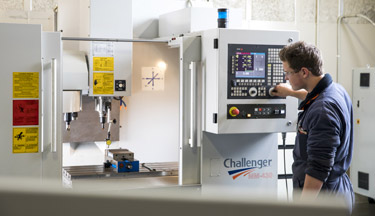 Manufacturing student working on a machine