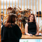 Student serving a customer in the salon