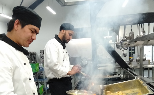 An image of students cooking for charity