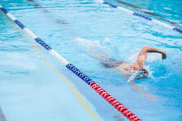 Student swimming laps of the pool