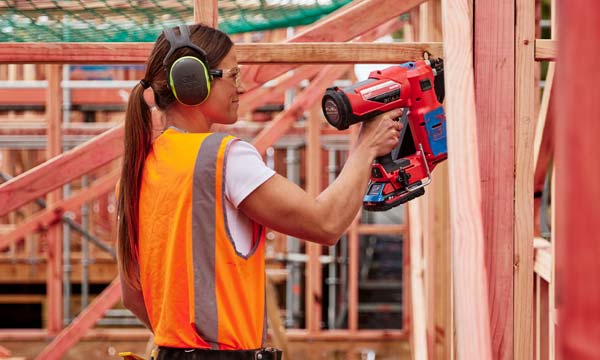 Carpentry student using nail gun