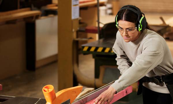 Carpentry student cutting up wood