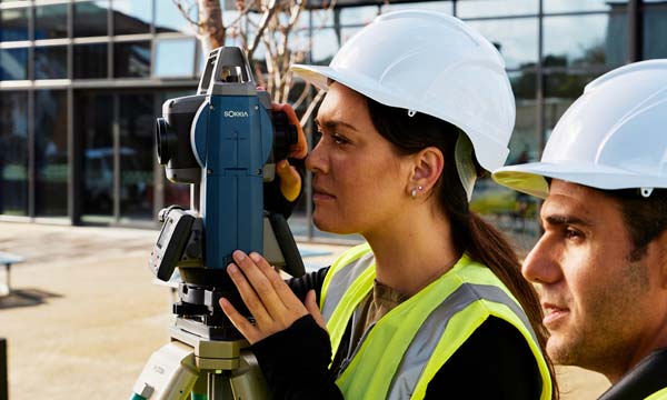 Surveying student using a theodolite