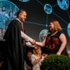 Graduate receiving certificate from tutor