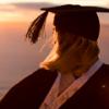 Graduate standing on top of Mount Maunganui
